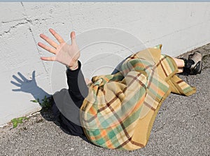 Very poor young beggar while he tries to rest on a bed on the sidewalk of the metropolis