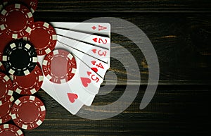 A very popular poker game with a winning combination of high cards. Cards with chips on a black vintage table in a poker club