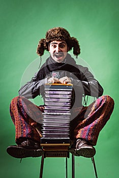 A very positive man with an accordion posing in the studio