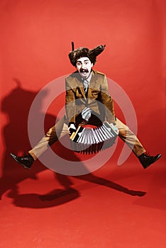 A very positive man with an accordion posing in the studio