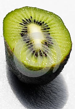 Very ripe kiwi fruit. The fruit is soft and juicy. The fruit is cut in half. Two halves of kiwi. Kiwi seeds and a very nice green