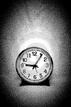 A very simple round black and white clock against empty background