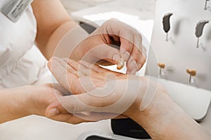 Very small hearing aid in hands