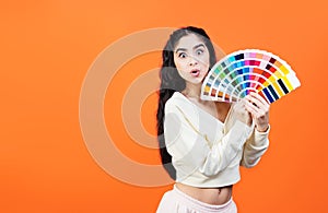 Very surprised woman with color palette fun. Paint and painting concept. Interior designer woman holding color palette guide