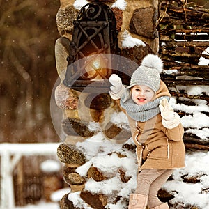 Very sweet beautiful little girl child in a beige coat crusade a