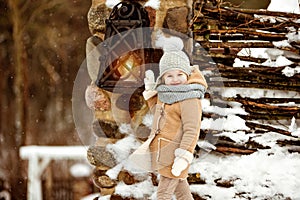 Very sweet beautiful little girl child in a beige coat defiantly