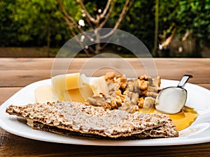 Very tasty italian healthy rustic breakfast with homemade cow`s milk cheese, walnuts, honey