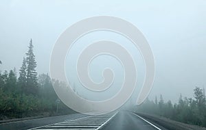 Very thick fog. The road disappearing into the fog. The concept of danger on the road