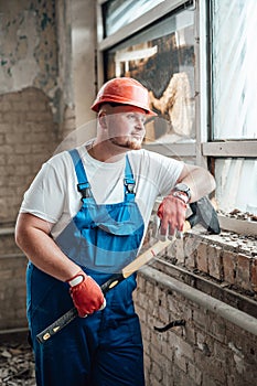 Very tired construction worker resting looking out of the window