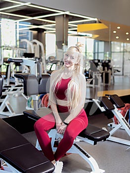 Very tired female in activewear sitting on bench