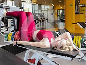 Very tired female in activewear sitting on bench