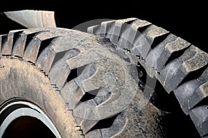 Very used off-road truck tires with two wheels on each axle. missing a sample that is badly worn, the driver can get a fine from t
