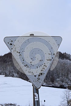 very weathered and rusty traffic sign