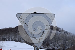 very weathered traffic sign