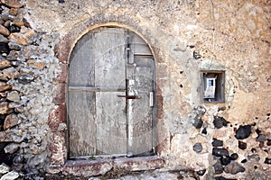 A very worn and battered old blue door