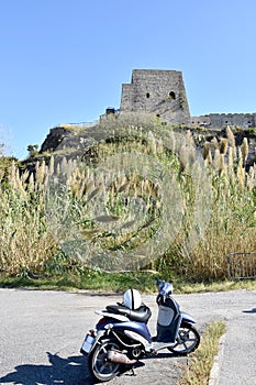 Vespa in front of Torre Talao in Scalea, Calabria