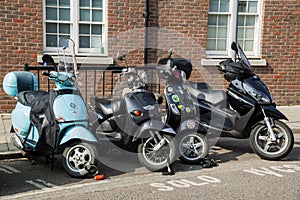 Vespa moped and scooters along with a motorbike