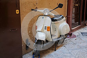 Vespa motorbike  secured against theft by chain