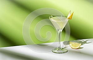 Vesper, classic alcoholic cocktail drink with dry gin, vodka, aperitif, lemon zest and ice. Light green background, hard light,