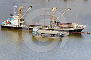 Vessel bulk cargo beside cargo boat