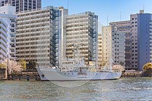 Vessel moored along housing complex in Tokyo.