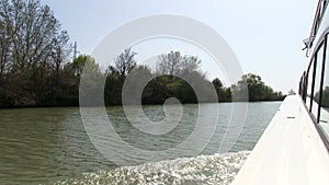 Vessel sails on the canal, view on coast