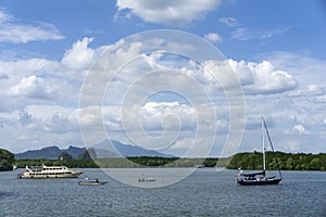 The vessels in the harbour over blue sky and white clouds