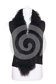 Vest isolated. Black women vest with a large fur collar on mannequin isolated on a white background. Woman fashion