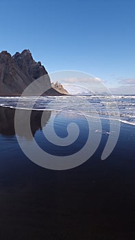 Vestrahorn mountains connect with ocean