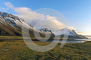 Vestrahorn snow mountain and Stokksnes beach near blue lake in H