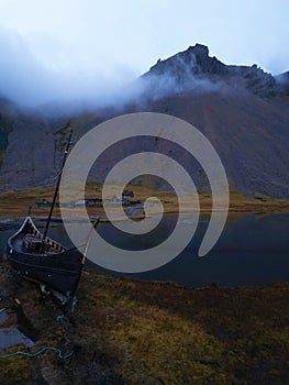 Vestrahorn viking ship and village covered with clouds.