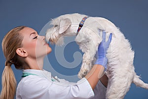 Vet holding a cute dog above head