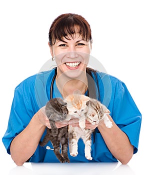 Vet holds three kittens. isolated on white background