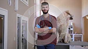 Vet in uniform with dog smiling arms crossed