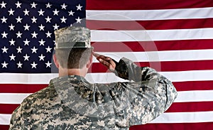 Veteran male solider saluting the flag of USA