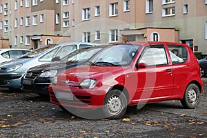 Old small red car Fiat Seicento 600 parked front view