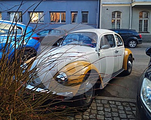 Vintage oldtimer veteran old classic retro car white and yellow VW Beetle parked