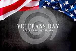 Veterans day. Honoring all who served. American flag on gray background with copy space