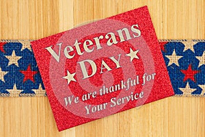 Veterans Day thank you type message on glitter red greeting card