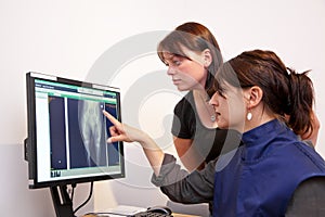 Veterinarian explaining x-ray picture