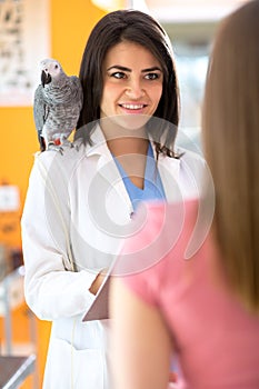Veterinarian is giving advices to a girl in vet infirmary