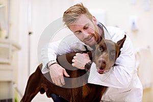 Veterinarian giving a hug to his patient
