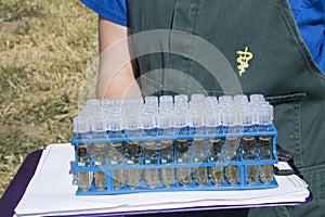 Veterinarian holding tray of test tubes