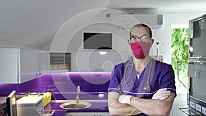 A veterinarian with a mask on his face looks into the camera. Pet care concept.