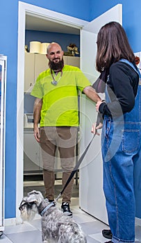 Veterinarian receiving a client with her pet