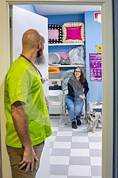 Veterinarian receiving a client with her pet