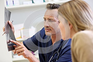 Veterinarian showing x-ray of pet to client