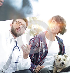 Veterinarian showing an x-ray to the owner of the dog.