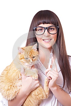 Veterinarian with a syringe in hand holds red cat