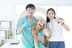 The veterinarian was with the dog and the dog owner in the examination room. Veterinary and owner show thmub up